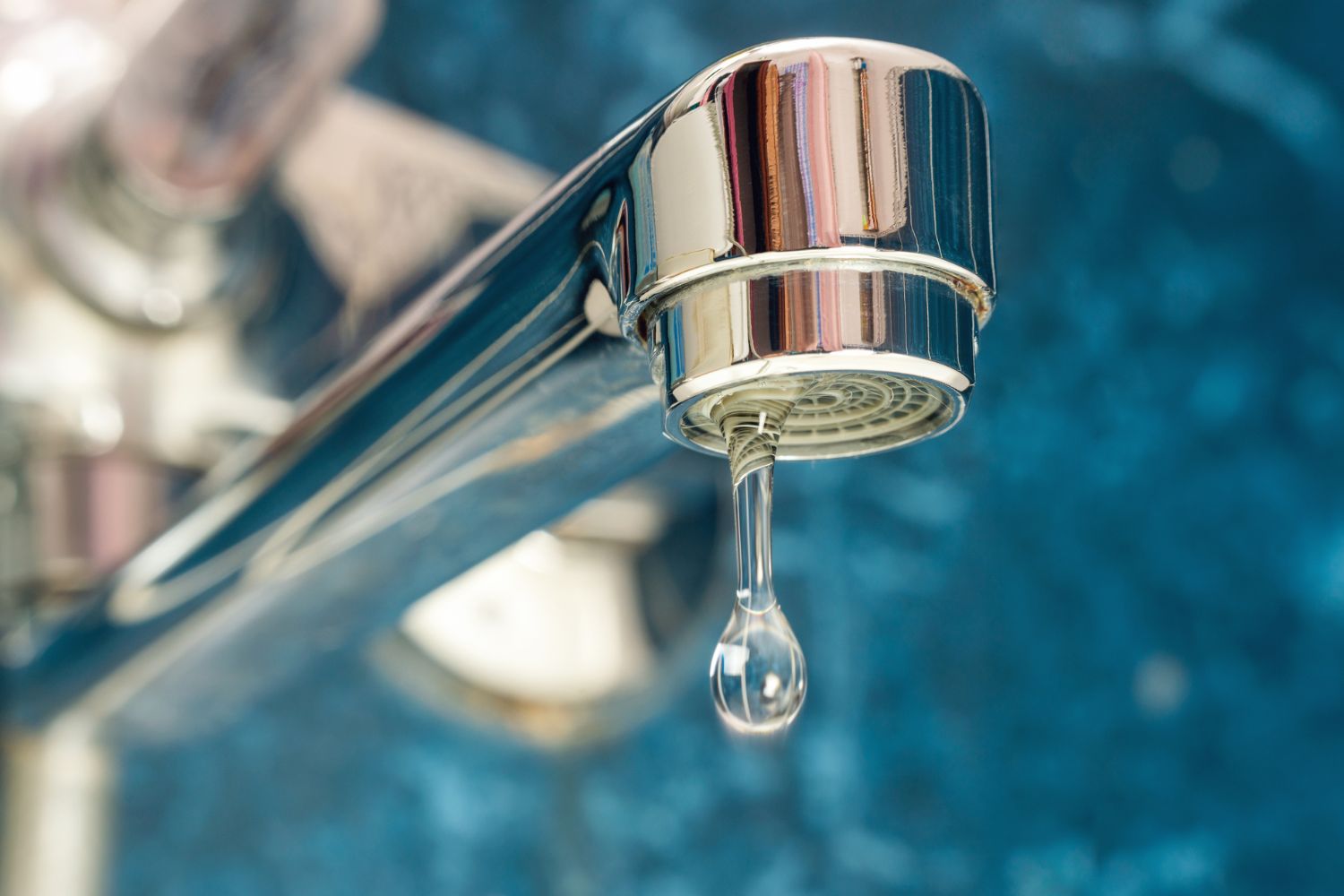 Water supply, A drop of water drips from a leaky faucet.