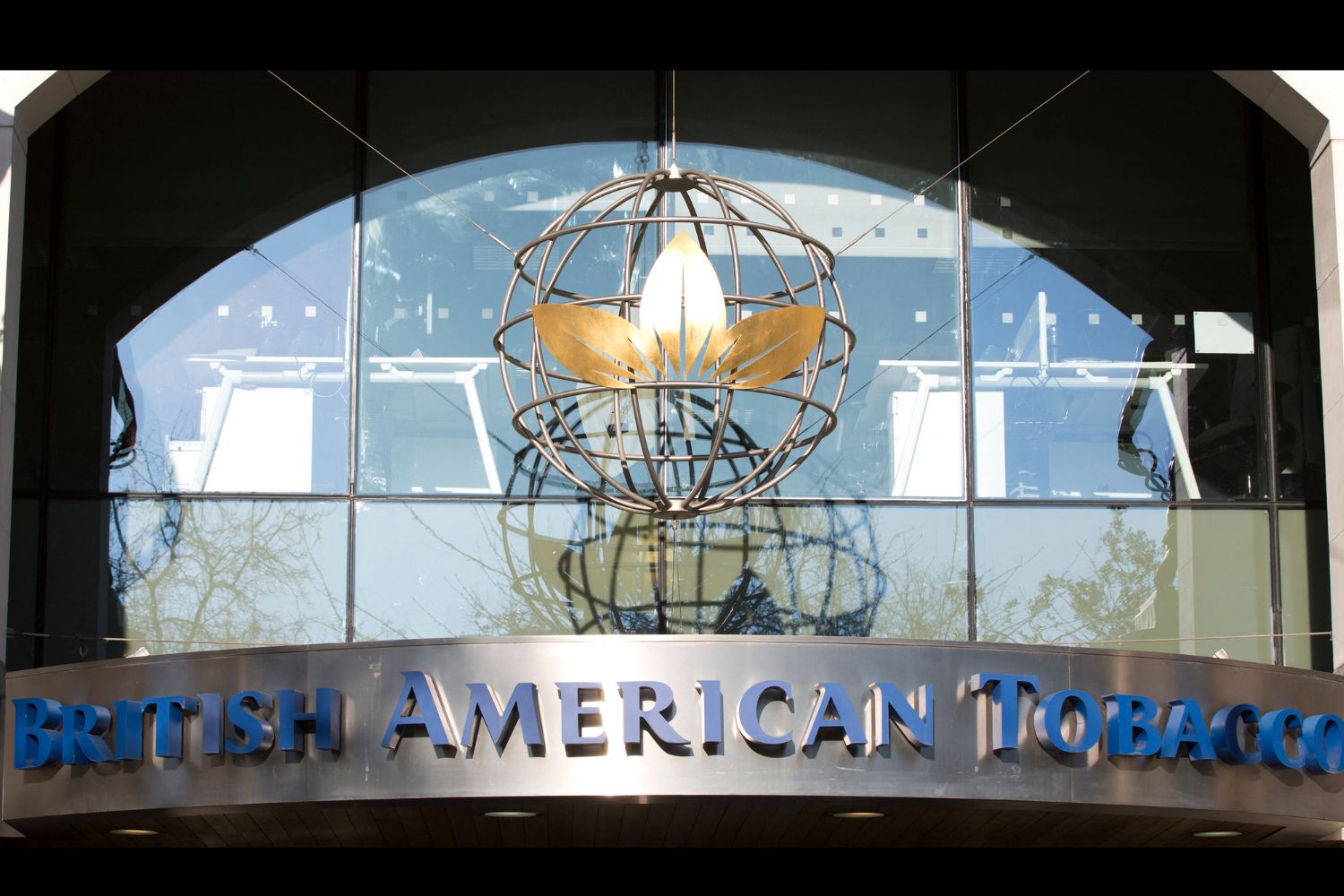 Signage is pictured on the front of the headquarters quarters of British American Tobacco at Temple Place in central London on January 17, 2017. British American Tobacco agreed on January 17, 2017 to pay almost 50 billion USD for control of US peer Reynolds American in a move which targets the lucrative United States market and the fast-growing e-cigarette sector. (Photo by Isabel Infantes / AFP)