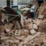 A boy stands amongst the rubble of his collapsed house in Dahejia in Jishishan County in northwest China's Gansu province on December 20, 2023. Survivors of China's deadliest earthquake in years huddled in aid tents on December 20 after overnight temperatures plunged well below zero, with the death toll rising to 131.