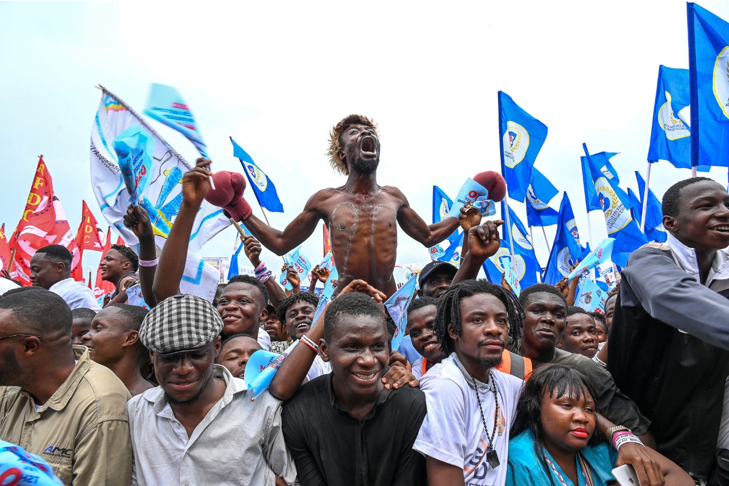 Supporters of President of the Democratic Republic of the Congo (DRC) and leader of the Union of Democracy and Social Progress (UDPS) party, Felix Tshisekedi, cheers during a campaign rally at Sainte Therese in the Ndjili district of Kinshasa on December 18, 2023. Forty-four million people are registered to vote in the presidential, parliamentary, provincial and municipal elections scheduled for December 20, 2023 in the central African nation of about 100 million people. (Photo by Arsene Mpiana / AFP)