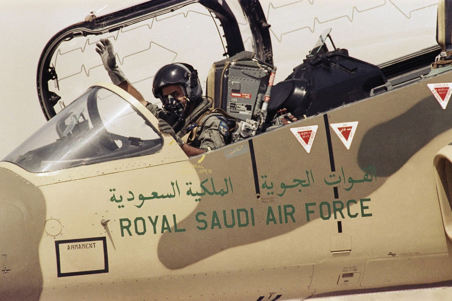 A pilot of the Royal Saudi Air Force waves to ground personnel to take off in his American made F-15 Eagle Fighter Jet on Wednesday, August 15, 1990 at an Air Base in Saudi Arabia. The Saudi Air Force is being augmented by American Air Power as they prepare to defend against the Iraqi military threat. (AP Photo/Scott Applewhite)