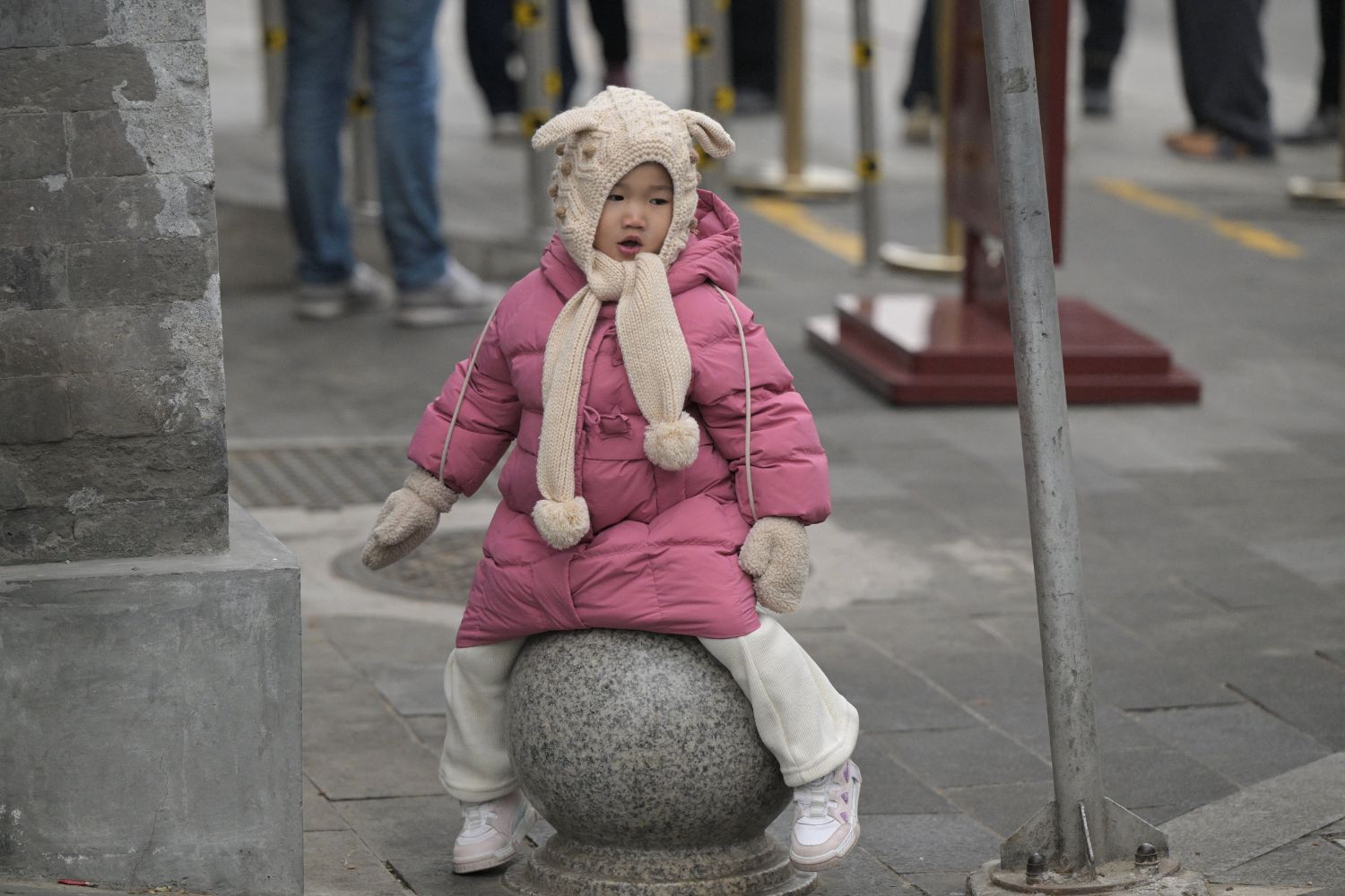 A toddler is seen on a street in Beijing on January 17, 2024. China's population decline accelerated in 2023, official data showed on january 17, 2024, extending a downward streak after more than six decades of growth as the country battles a looming demographic crisis. (Photo by Pedro PARDO / AFP)