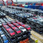 The file photo taken on September 11, 2023 shows BYD electric cars waiting to be loaded on a ship stacked at the international container terminal of Taicang Port at Suzhou Port, in China’s eastern Jiangsu Province. China's BYD has overtaken US electric vehicle giant Tesla as the world's leading EV deliverer, according to recent sales figures. (Photo by AFP) / CHINA OUT - China OUT