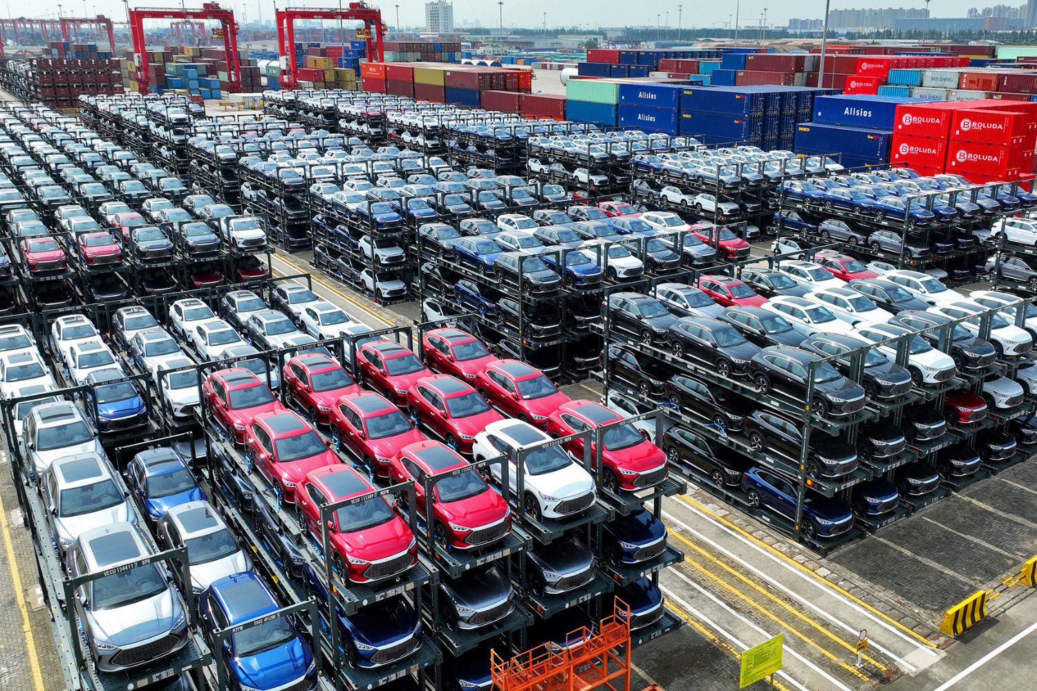 The file photo taken on September 11, 2023 shows BYD electric cars waiting to be loaded on a ship stacked at the international container terminal of Taicang Port at Suzhou Port, in China’s eastern Jiangsu Province. China's BYD has overtaken US electric vehicle giant Tesla as the world's leading EV deliverer, according to recent sales figures. (Photo by AFP) / CHINA OUT - China OUT