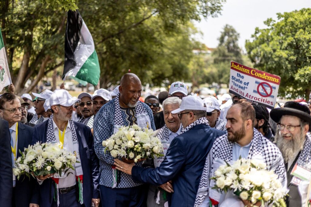 Nelson Mandela's grandson and South African politician Zwelievile, Mandela Mandela (3L) carries a flower wreath to be deposed by the statue of Nelson Mandela on the lawns of the Union Building in support of the Palestinian struggle during the Mass Demonstration March to Union Building to commemorate the 10th Anniversary of the death of former South African President Nelson Mandela in Pretoria, on December 05, 2023. (Photo by Roberta Ciuccio / AFP)