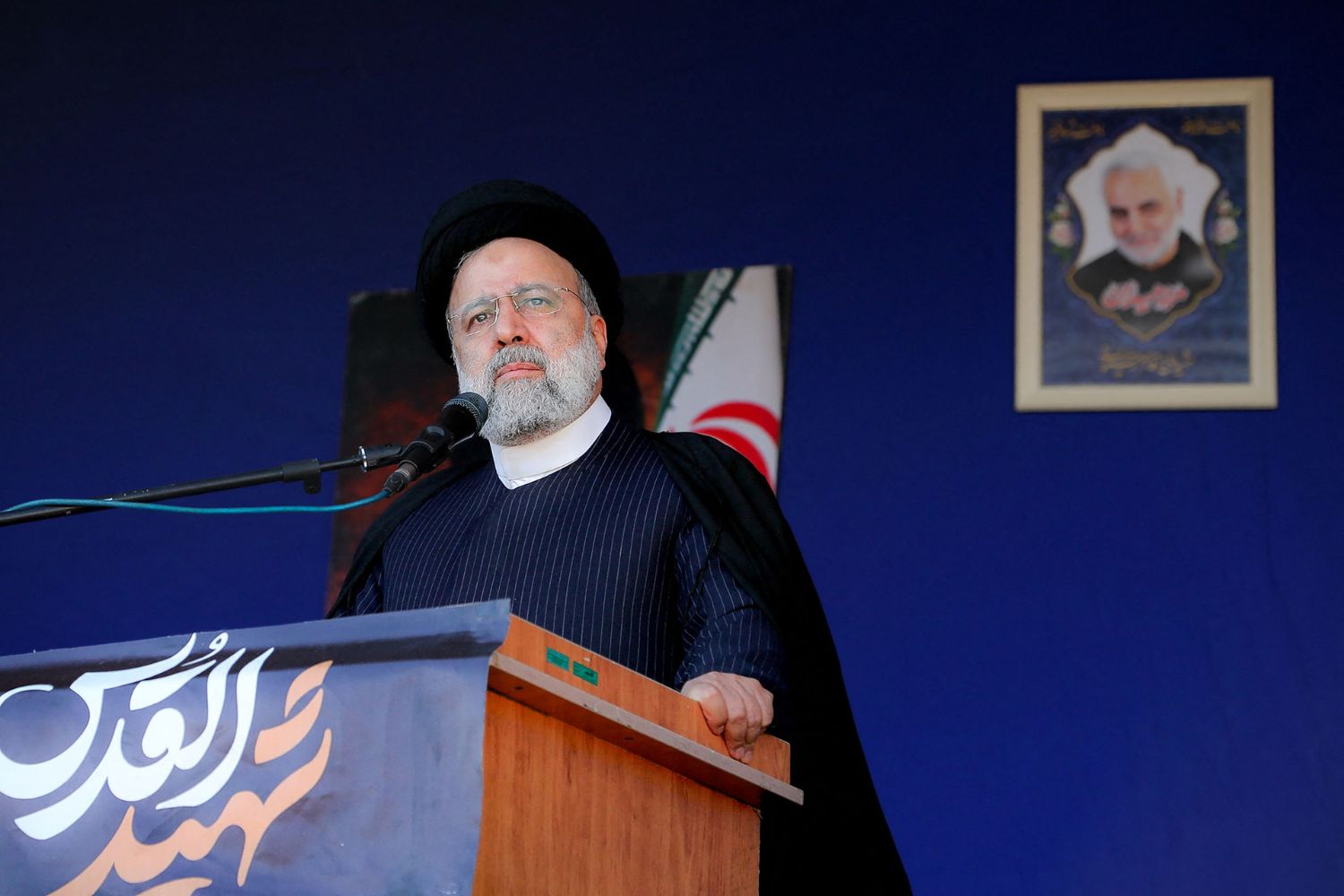 his handout picture provided by the Iranian presidency on January 5, 2024, shows Iran's President Ebrahim Raisi speaking during the funeral of victims killed in twin blasts on January 3, as they took part in a commemmoration marking the anniversary of the killing of Revolutionary Guards general Qasem Soleimani in the southern city of Kerman. Iranian President Ebrahim Raisi joined mourners in Kerman on January 5 for the funerals of the 89 people killed in twin blasts claimed by the Islamic State group, state media said. (Photo by Iranian Presidency / AFP)