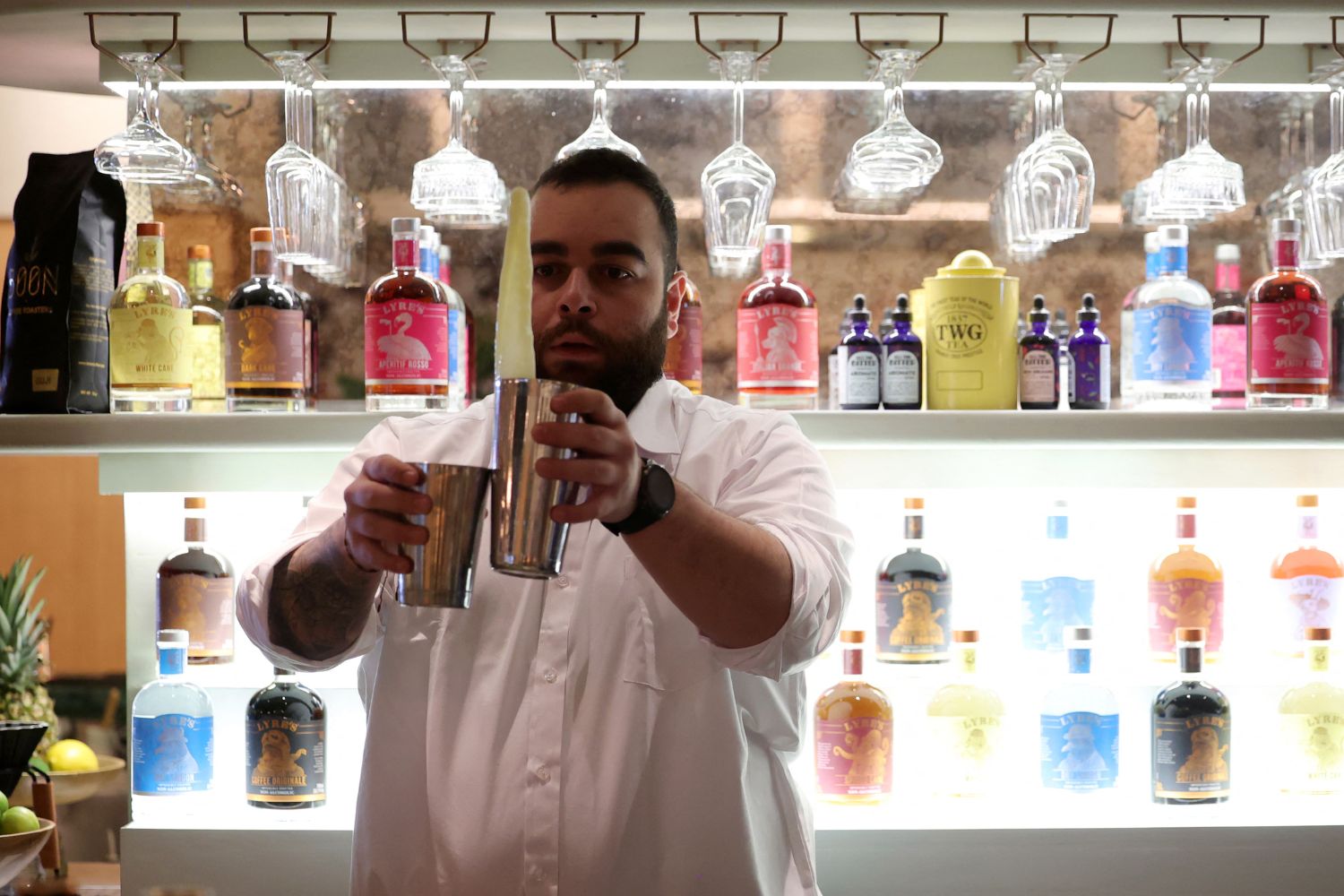 Lebanese bartender Hadi Ghassan prepares a drink behind the counter at "Meraki Riyadh", a pop-up bar offering non-alcoholic bellinis and spritzes, served in chilled cocktail glasses, in Riyadh on January 23, 2024. The bar's success highlights widening acceptance of more daring non-alcoholic fare even as booze itself remains strictly off-limits in the Gulf kingdom, home to Islam's holiest sites. (Photo by Fayez Nureldine / AFP)