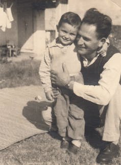 A black and white photograph of a man and a young boy.