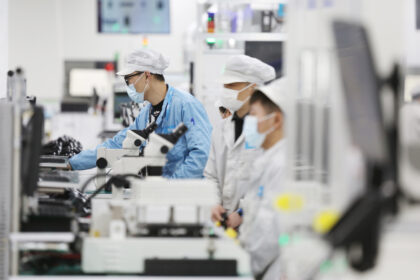 Employees work at Flextronics International Ltd's China unit in Suzhou, Jiangsu province.