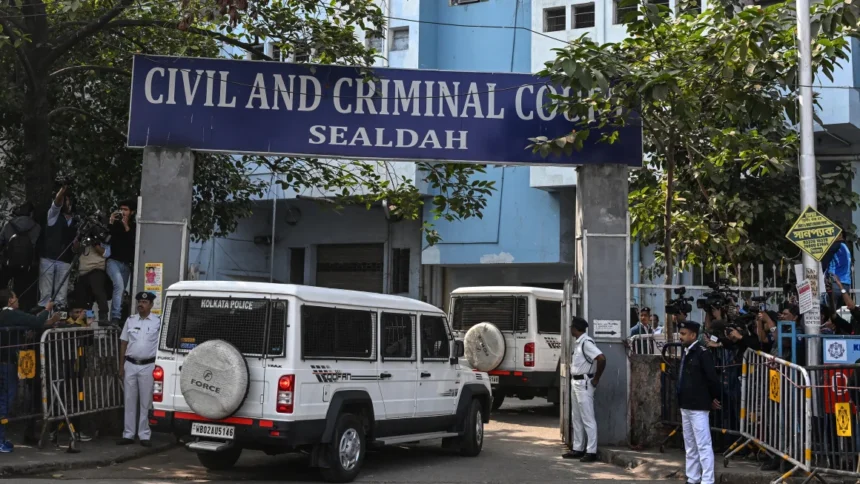 Police personnel stand guard at the entrance of the Civil and Criminal Court Sealdah in Kolkata on January 18 2025.